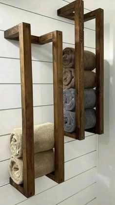 two wooden shelves holding towels and folded towels