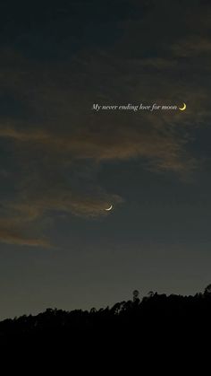 the moon and venus are visible in the night sky above some hills with trees on it