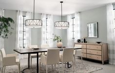 a dining room table with white chairs around it