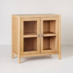 a wooden cabinet with two doors and shelves