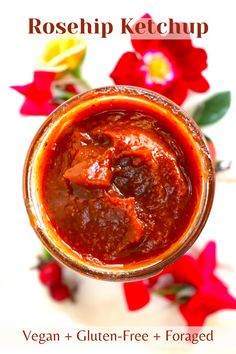 a close up of a cup of food on a table with flowers in the background