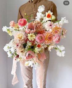 a person holding a large bouquet of flowers