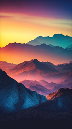 the mountains are covered in colorful clouds at sunset