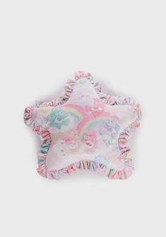 a pink pillow with unicorns on it and a star shaped pillow in the middle