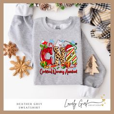 Bring some holiday cheer to all your patients with our super cute CNA Christmas shirt!  These shirts are perfect for wearing to work during the holiday season to spread a little cheer.  This shirt also looks great at all those Christmas gatherings and makes the perfect shirt for office Christmas photos!   Our processing time is 3-5 business days.  Large quantity orders can have delayed shipping.  If you need by a specific date, please be sure to let us know.   Materials: All shirts are made with Fun Graphics, Shirt Store, Custom Christmas, Everyday Wardrobe, Perfect Shirt, Neck Shirt, Baby Bodysuit, Unisex Hoodies, Sweat Shirt