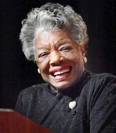 an older woman sitting at a table smiling