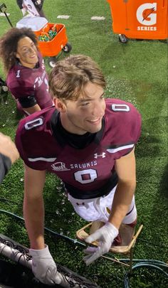 two football players in uniform on the field