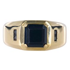 A true masterpiece of timeless elegance. Featuring a meticulously crafted 3.6mm shank and an eye-catching head size of 10.75mm, this ring is designed to adorn a size 9.75 finger with effortless style. At its heart lies a mesmerizing square-cut onyx, measuring 8x8mm, exuding an aura of mystery and allure. Accentuating its exquisite beauty are four round brilliant-cut black diamonds, each weighing 0.015 carats, adding a touch of glamour and refinement.  Shank size: 3.6mm Head size: 10.75mm Ring si Luxury Onyx Diamond Ring For Formal Occasions, Formal Black Jewelry With Prong Setting, Black Round Cut Jewelry For Formal Occasions, Luxury Formal Emerald Ring With Channel Set, Luxury Onyx Rings For Formal Occasions, Luxury Channel Set Emerald Ring For Formal Occasions, Fine Jewelry Yellow Gold Rings With Onyx, Fine Jewelry Yellow Gold Onyx Rings, Classic Black Rings With Accent Stones