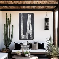 a living room filled with lots of furniture and plants