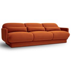 an orange couch sitting on top of a white floor