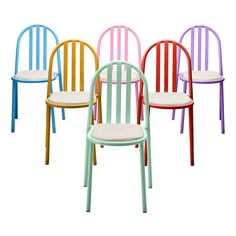 four different colored chairs with white cushions