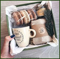 a person holding a coffee cup and some cookies