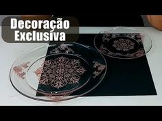 two black and pink plates sitting on top of a white tablecloth covered table cloth