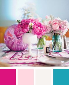 pink and blue flowers in vases on a table with matching colors for the centerpiece