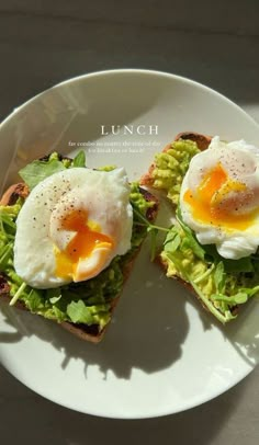 an egg and avocado sandwich on toast with lettuce is served on a white plate