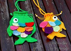 two crocheted fish bags sitting on top of a wooden table next to each other