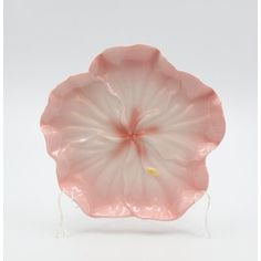 a pink flower shaped glass dish on a stand