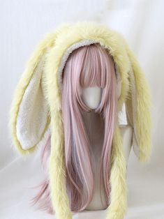 a wig with long pink hair and bunny ears on it's head is shown in front of a white background