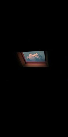 the sky is very dark and there are clouds in the window sill above it