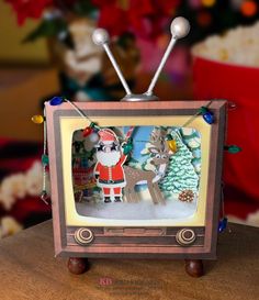 an old fashioned television with christmas decorations on it