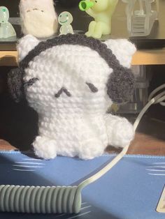 there is a crocheted stuffed animal with headphones on it's ears