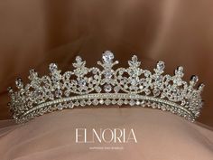 a tiara is shown on top of a white cloth with the word elnora written below it