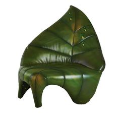 a green chair that is shaped like a leaf and has buttons on the back end