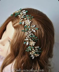 a close up of a headpiece on a mannequin's head with flowers and leaves