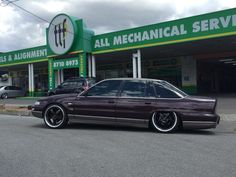 a purple car parked in front of a gas station