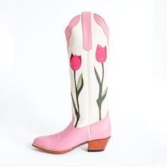 Step up your style game with these Pink Tulips Below The Knee Heeled Cowboy Boots for Women. The perfect blend of elegance and charm, these boots are a must-have for any fashion-forward woman. Color: Pink Heel Type: Block heel Heel height: 2" / 50 mm approx Product measurements were taken using size 8. Please note that measurements may vary by size. Toe: Pointed Toe Handcrafted US sizing. Fits true to size. Heeled Cowboy Boots, Embroidered Chunky Heels, Knee High Cowboy Boots, Cowboy Boots For Women, Glamour Vintage, Craft Board, Purple Heels, Tulip Print, Purple Tulips