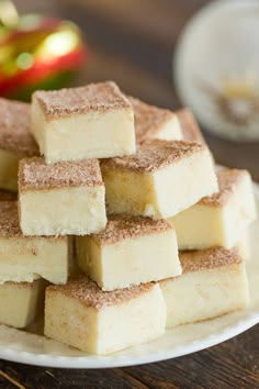 there are many pieces of cake on the plate and one is stacked high with sugar