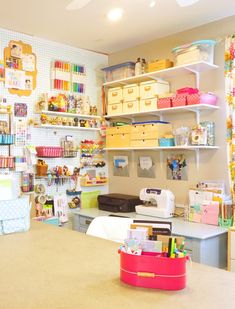 a sewing room with lots of craft supplies