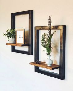 there are two wooden shelves with plants in them on the wall next to each other