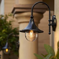 an outdoor light is hanging on the side of a building