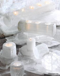 white candles are sitting on some ice