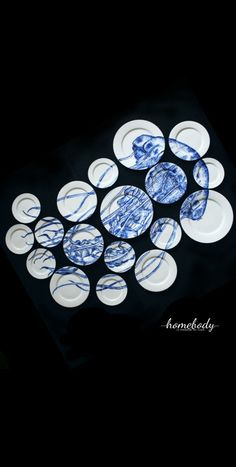 blue and white plates are arranged on a black tablecloth with the words, i am somebody written in it