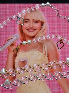 a woman in a white dress with pearls and beads around her neck is smiling at the camera