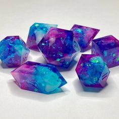 six purple and blue dices sitting on top of a white table next to each other