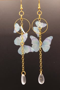 Butterfly Elegance Earrings - Unique Handmade Jewelry Delight in the whimsical charm of these handcrafted earrings, featuring delicate butterfly accents paired with elegant gold hoops and enchanting teardrop pendants. Designed for versatility and personalization, these earrings can be crafted for pierced ears or as clip-ons to suit your preference. Each pair is a one-of-a-kind creation, ensuring no two are exactly alike. Available in various lengths and color combinations, these earrings are per Orchid Earrings, Butterfly Earring, Earrings Butterfly, Delicate Butterfly, Whimsical Jewelry, Magical Jewelry, Wire Crafts, Handmade Jewelry Diy, Earring Ideas