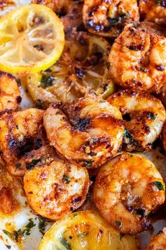 grilled shrimp and lemons on a white plate