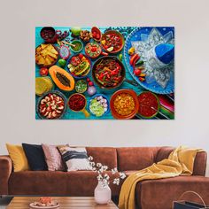 a living room filled with lots of food on top of a wooden table next to a brown couch