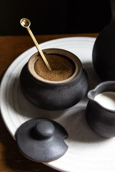 an assortment of black pottery on a white plate