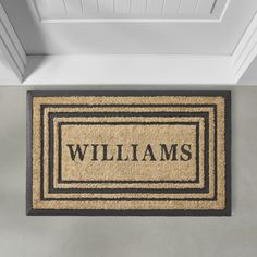 a door mat with the name williams on it in front of a white wall and doorway