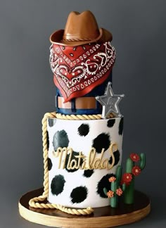 a cake decorated with cow print and cowboy hats