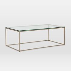 a glass and metal coffee table with a clear top on an isolated white background,