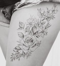 the back of a woman's thigh with flowers on it and text that reads, photo