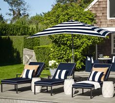 lounge chairs and an umbrella on a patio