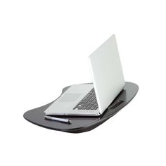 an open laptop computer sitting on top of a black desk tray with a pen and paper