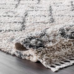 an area rug with grey and white colors