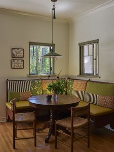 a dining room table and bench in front of a window